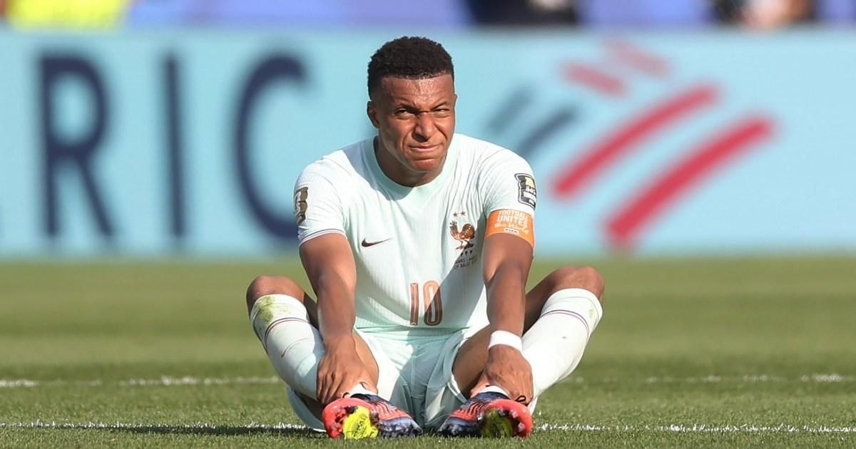 Kylian Mbappe injured on the field during a match