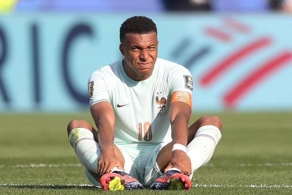 Kylian Mbappe injured on the field during a match