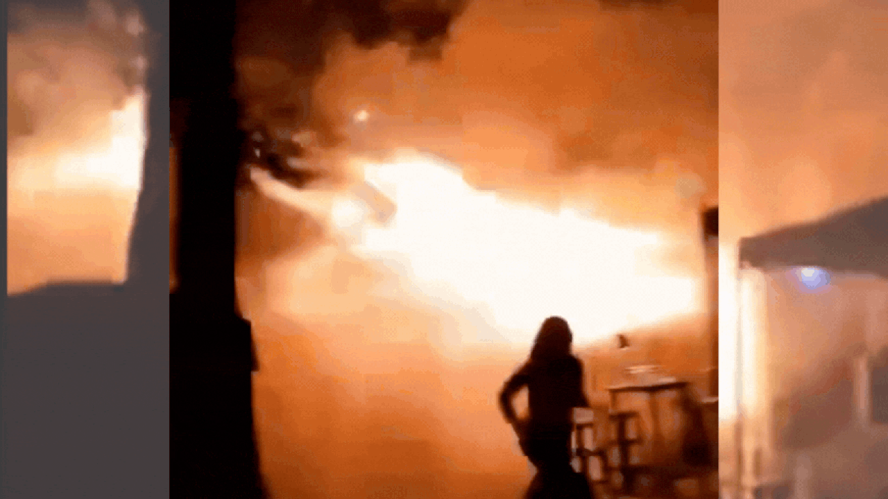 People gathered outside a burning pub in Bangkok