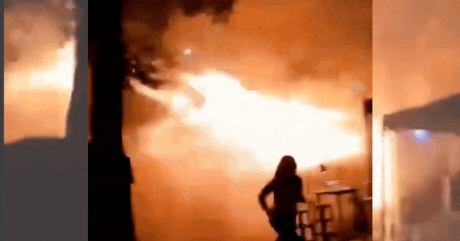 People gathered outside a burning pub in Bangkok