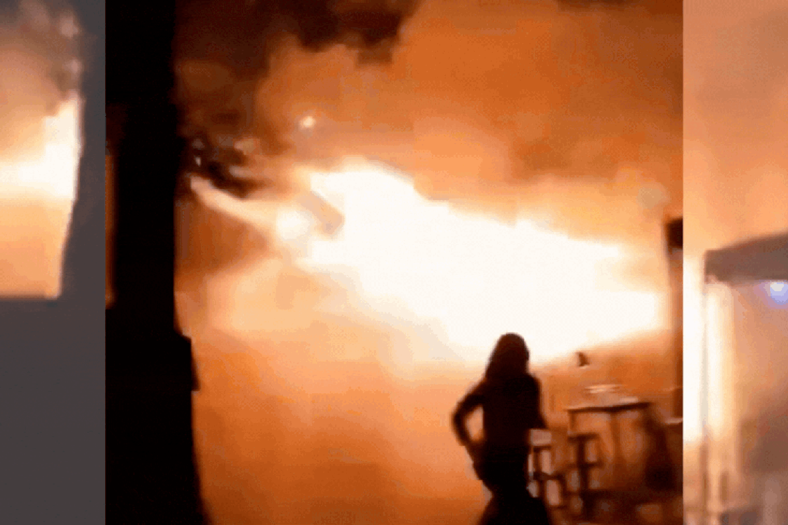 People gathered outside a burning pub in Bangkok