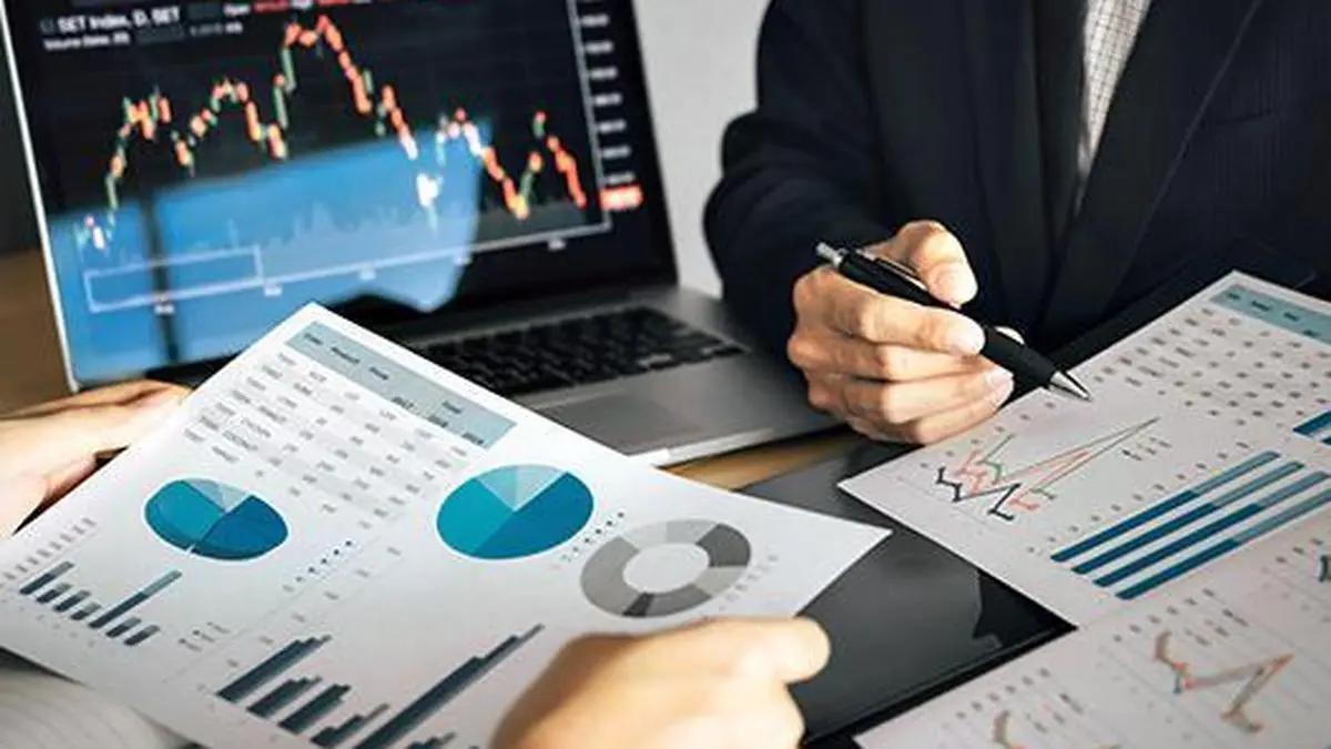 Business professionals analyzing stock market data on computers