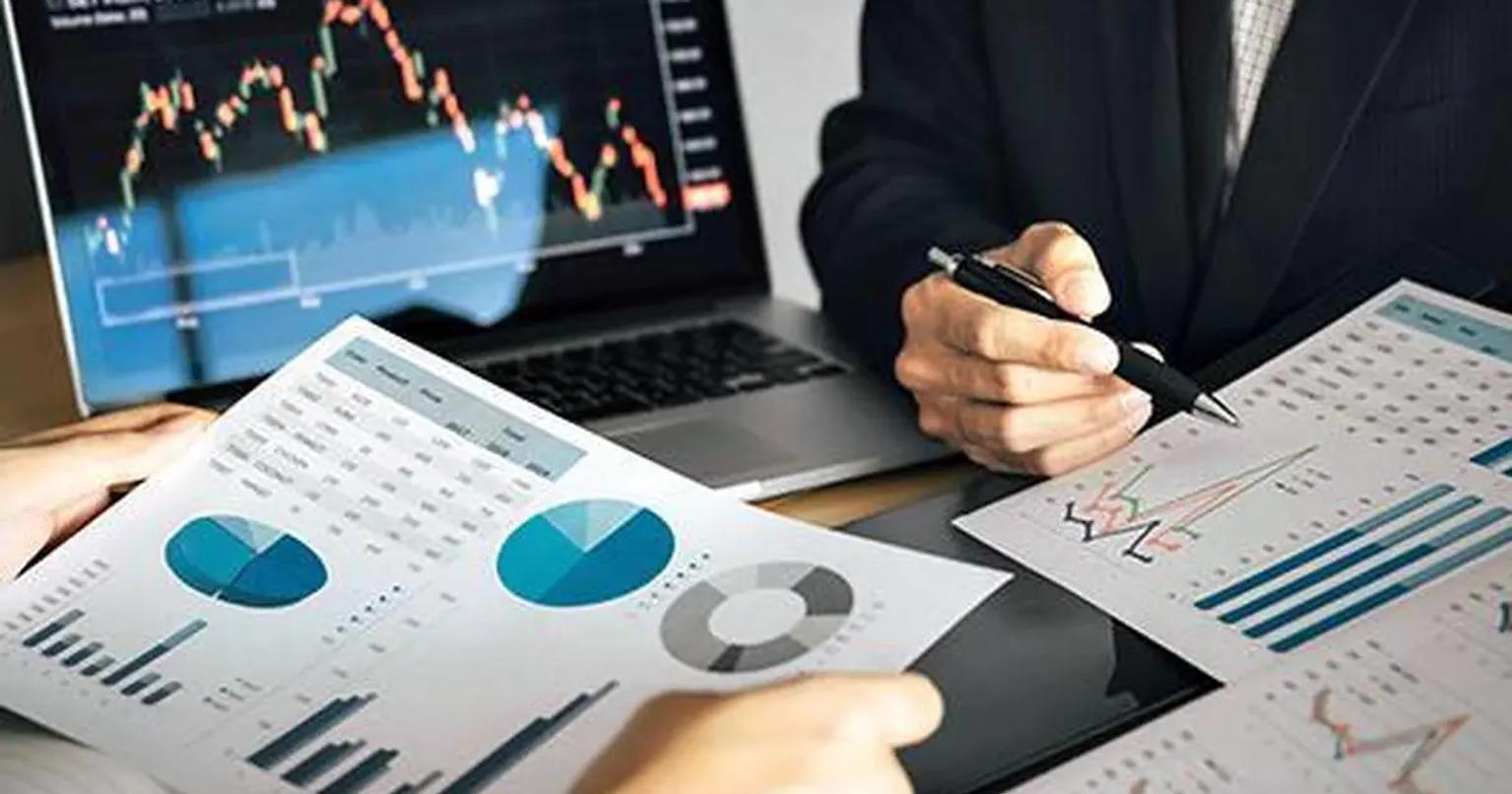 Business professionals analyzing stock market data on computers