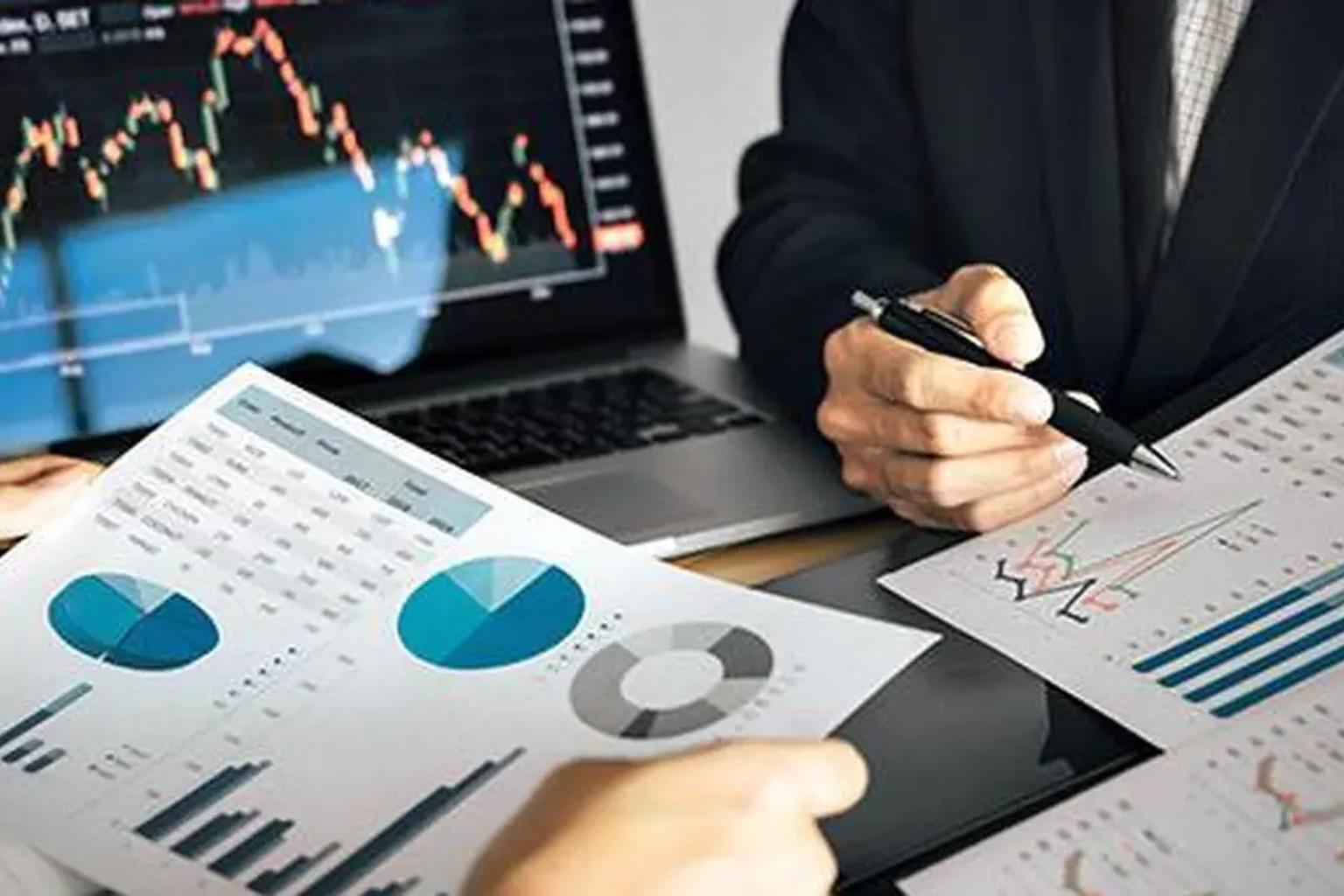 Business professionals analyzing stock market data on computers