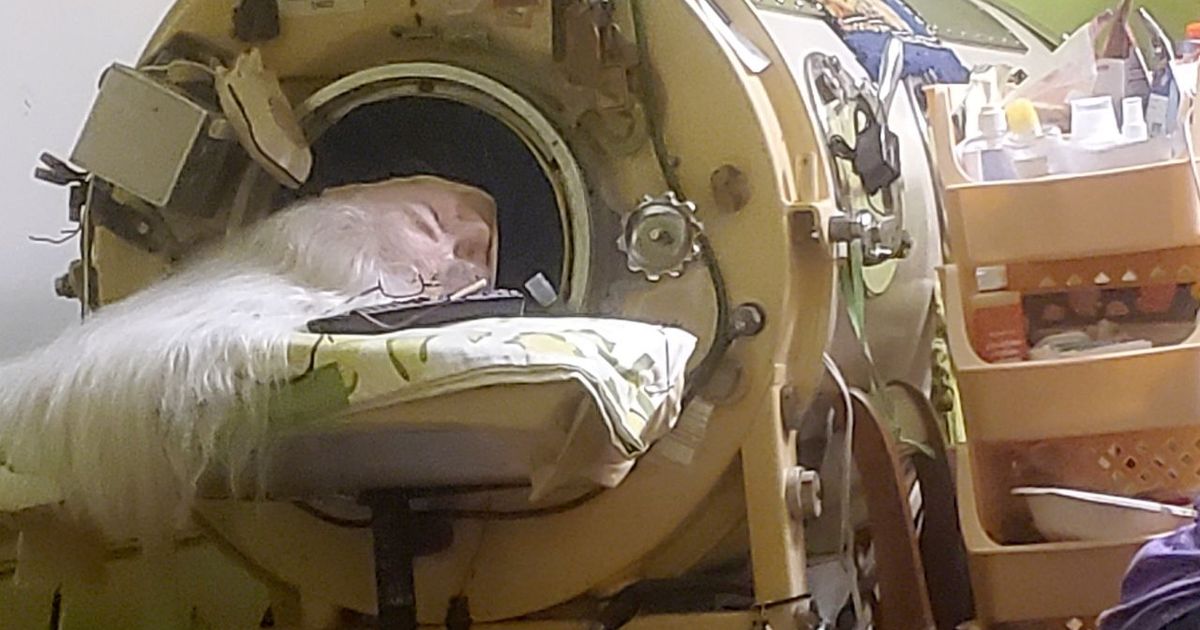 Martha Lillard in her iron lung with a determined expression