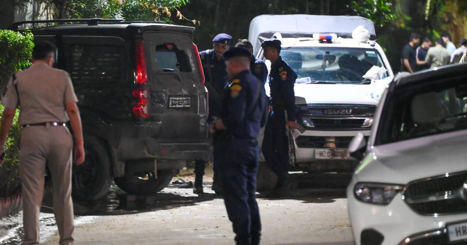 Police officers at the scene of the shootout in Gurgaon's Sushant Lok