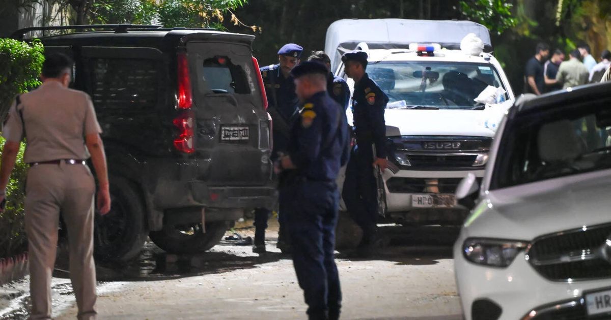 Police officers at the scene of the shootout in Gurgaon's Sushant Lok