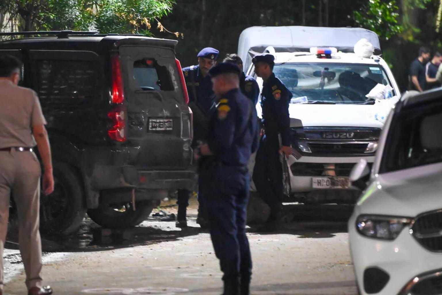 Police officers at the scene of the shootout in Gurgaon's Sushant Lok
