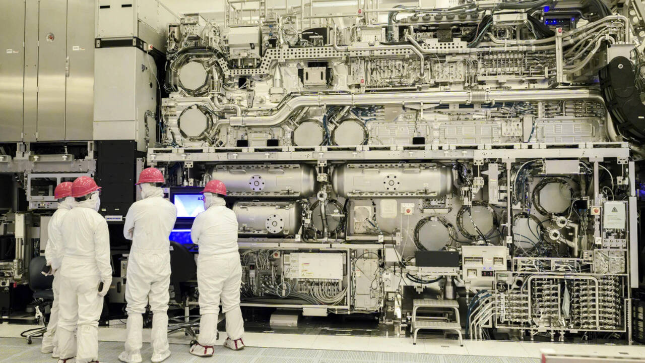 Scientists working on a complex machine in a laboratory