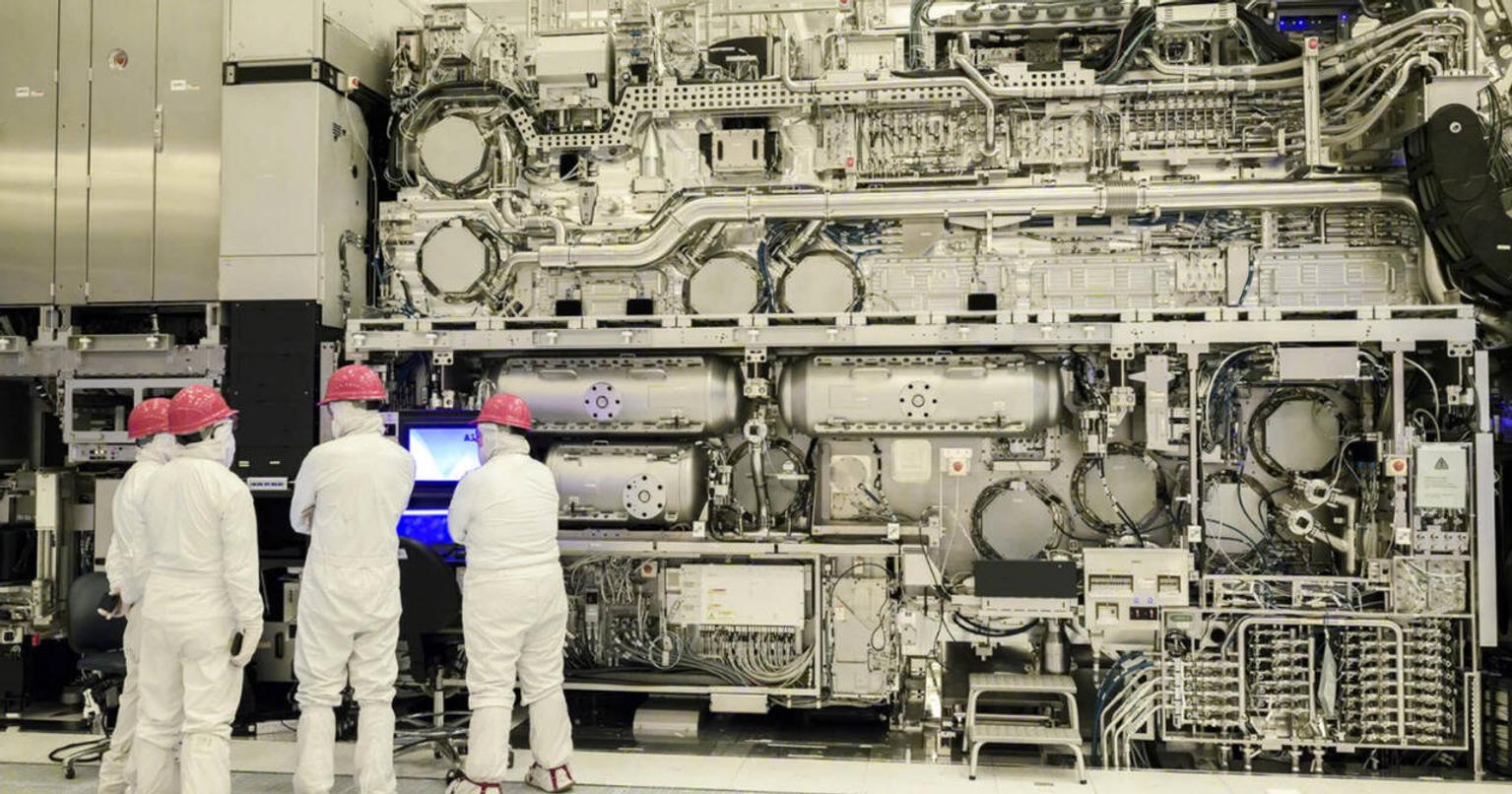 Scientists working on a complex machine in a laboratory