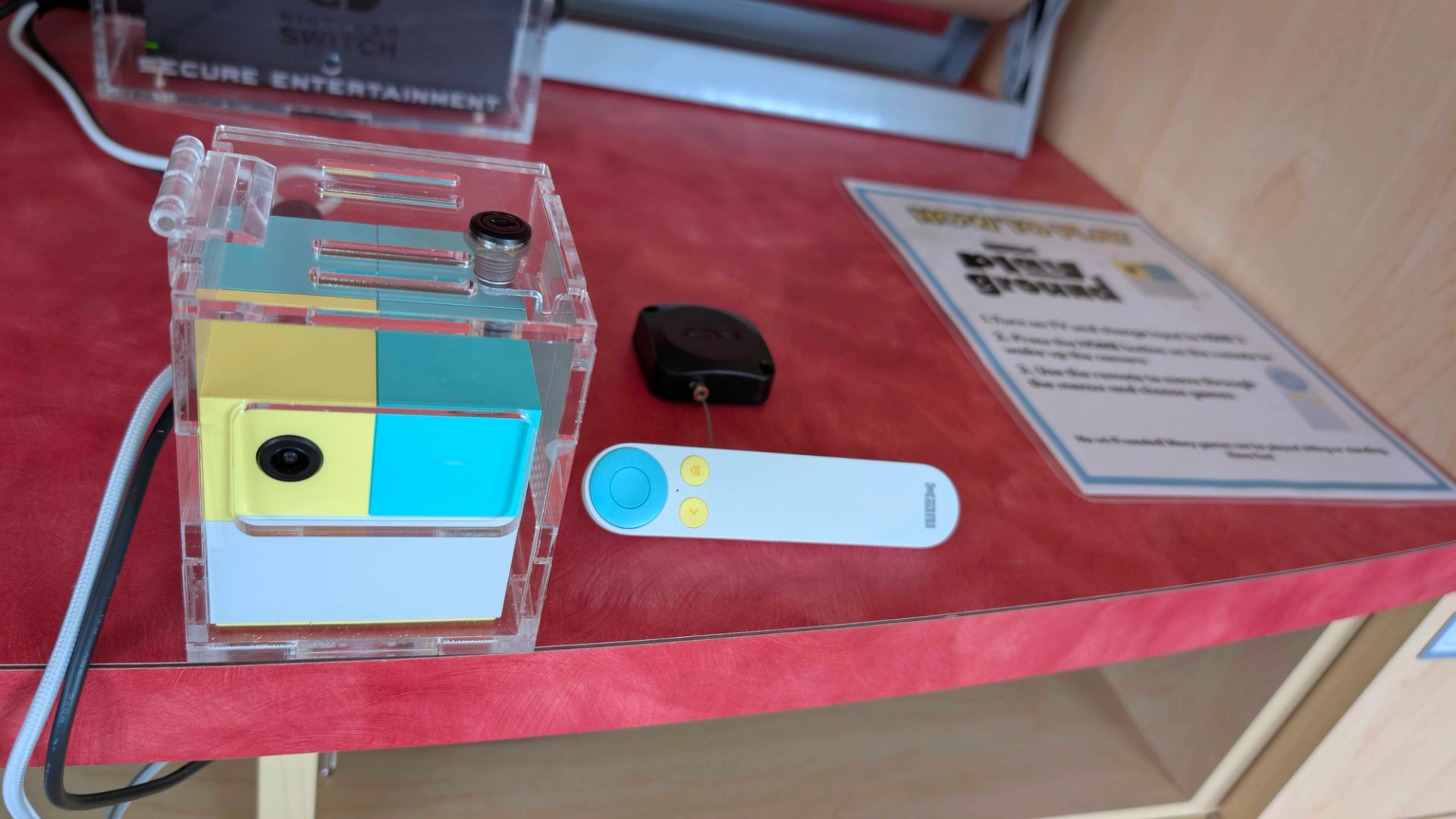 The Nex Playground and remote control featured being used in a hospital setting, perched on a red table.