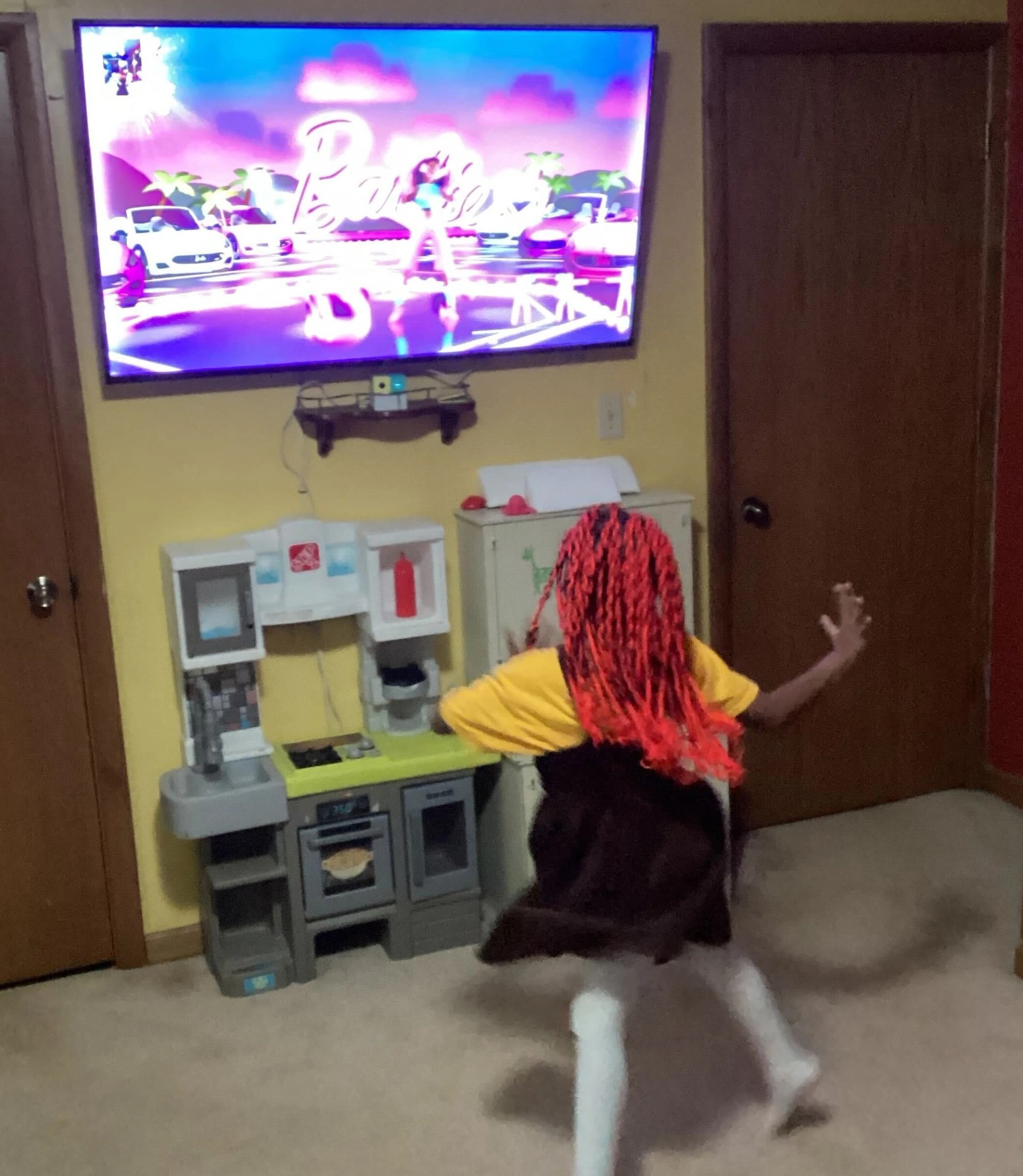 Nex Playground being played in foster homes, a young girl plays Barbie
