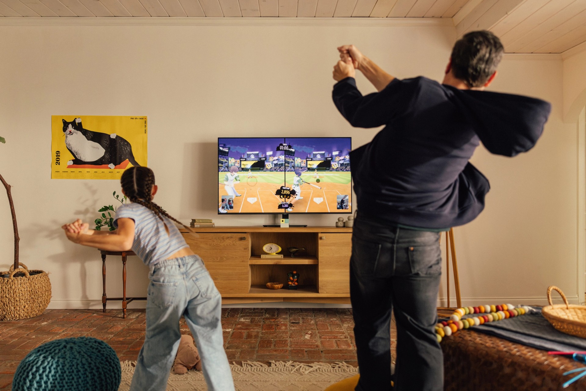 Father and daughter in living room playing Homerun Heroes: Starstrikers on Nex Playground with Play Pass.