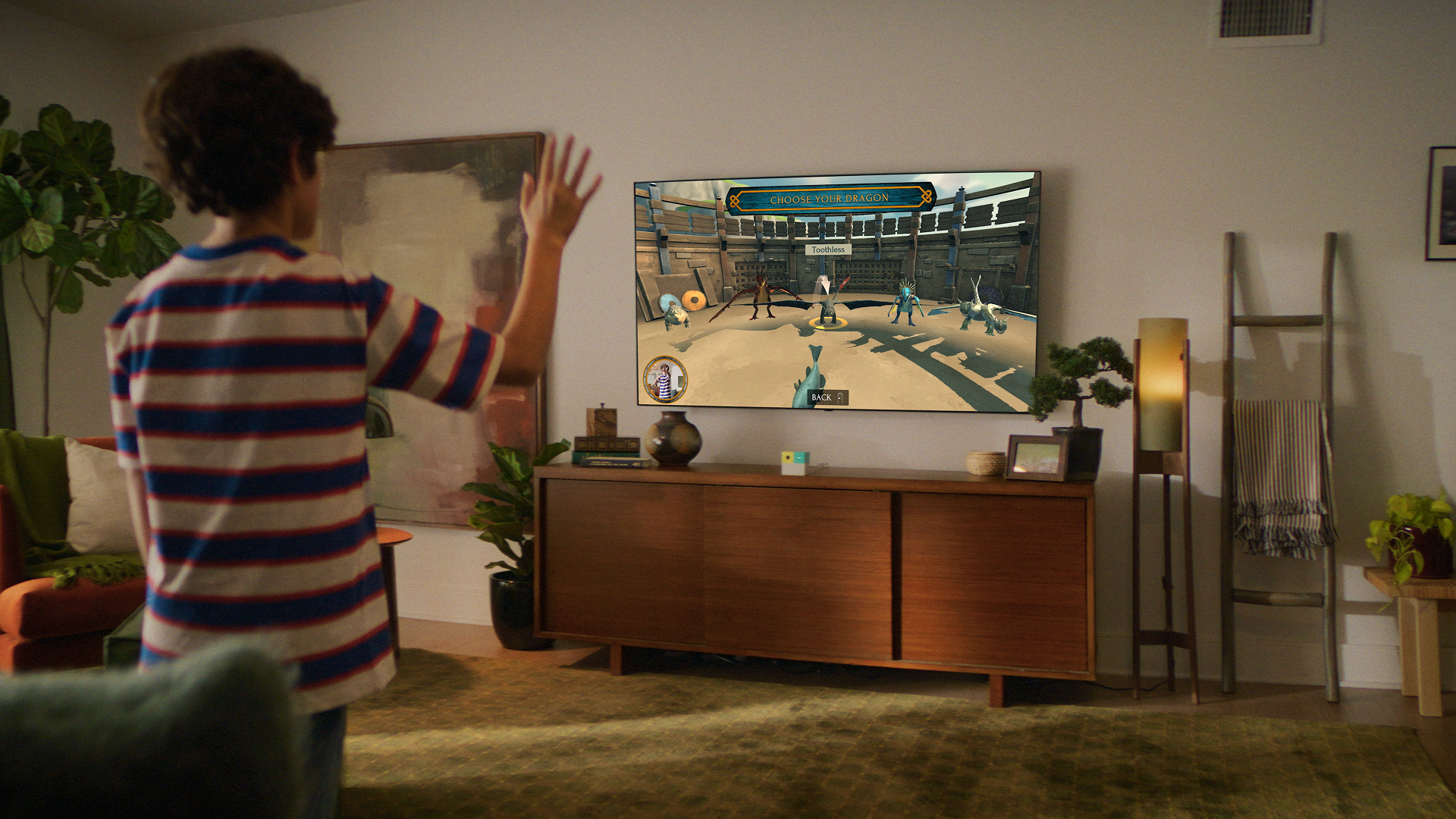 Boy using motion controls to choose a dragon in the Nex Playground How to Train Your Dragon game.