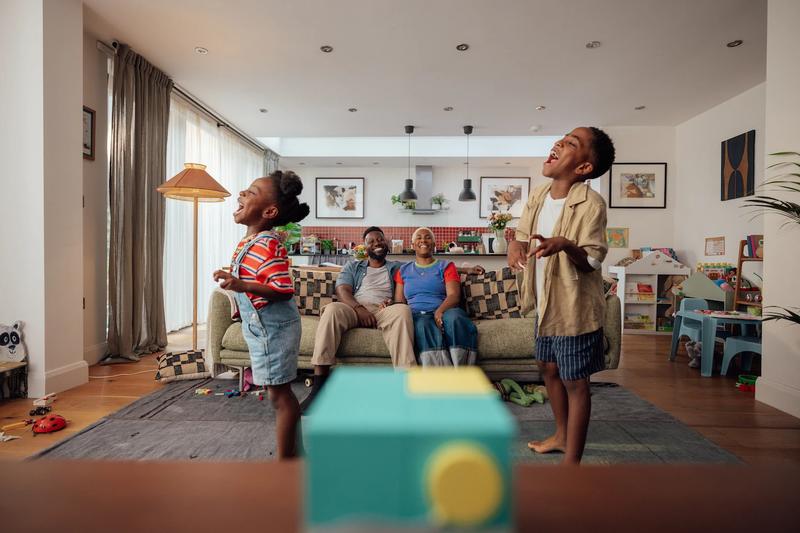 family in living room playing
