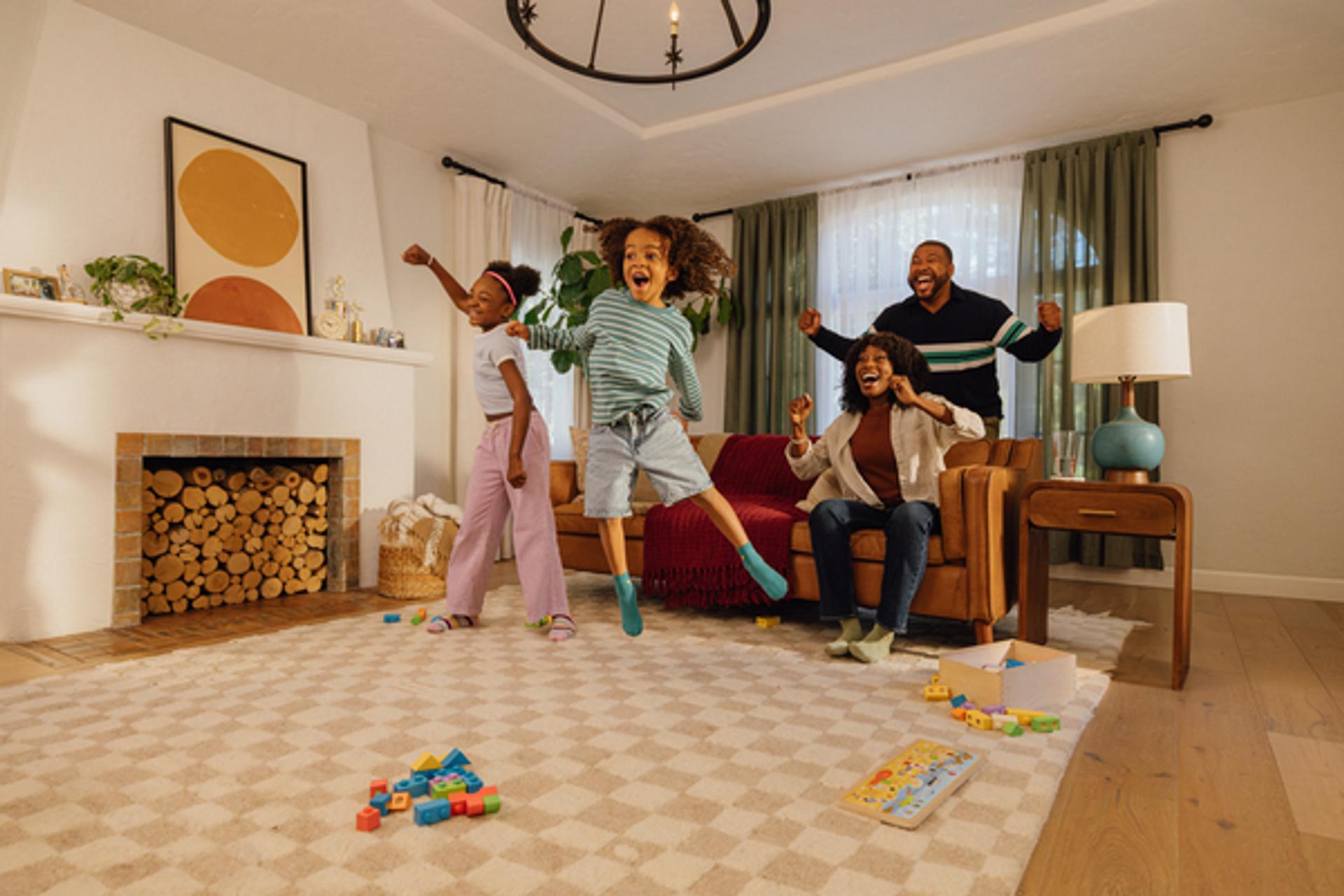 Family of four playing in their living room with Nex Playground.