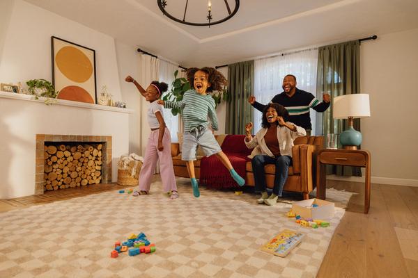 Family of four playing in their living room with Nex Playground.
