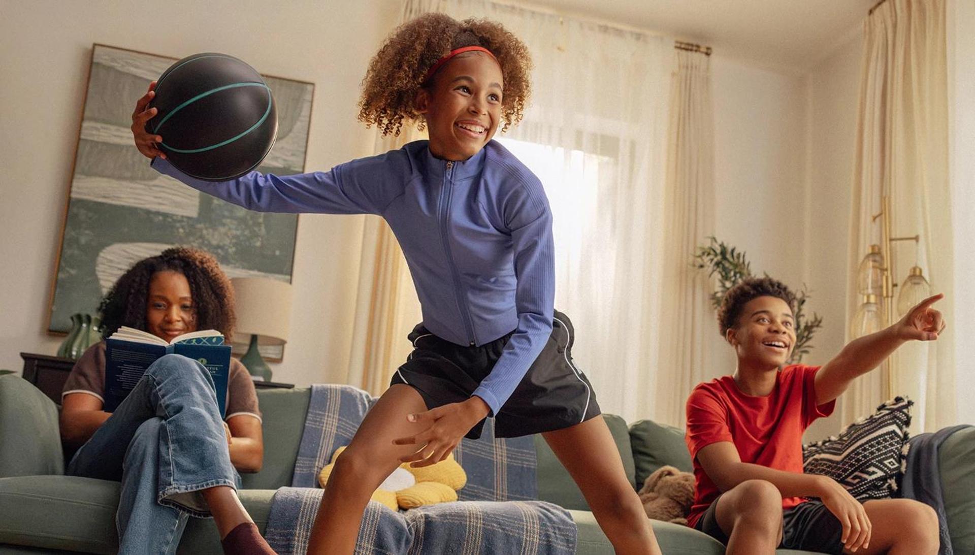 Girl playing with a Nex Quiet Basketball in her living room