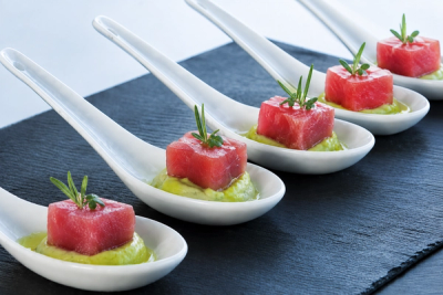 Spoons of tuna bites served over avocado mousse