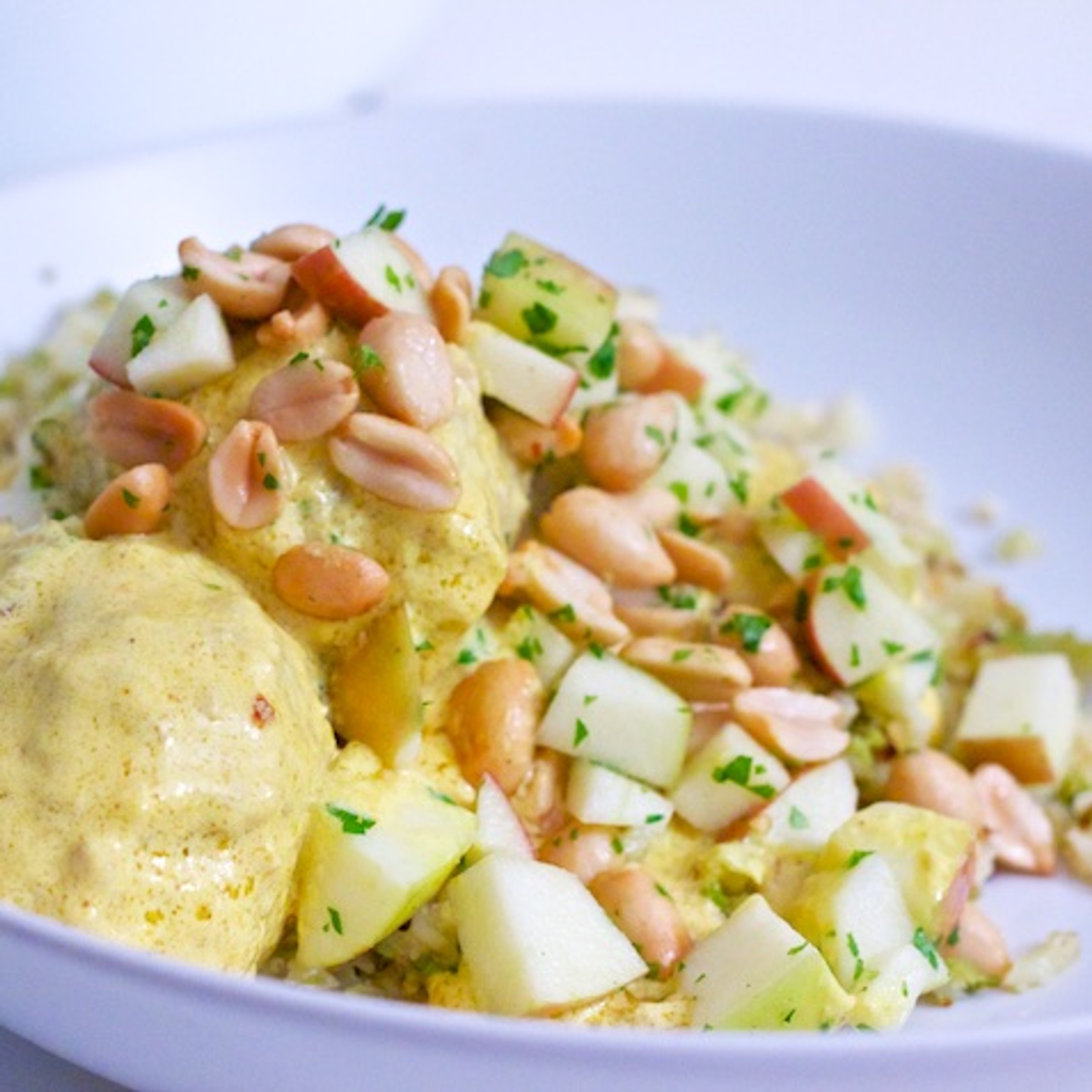 Boller i karry med grøntsagsris og drys af æbler og peanuts