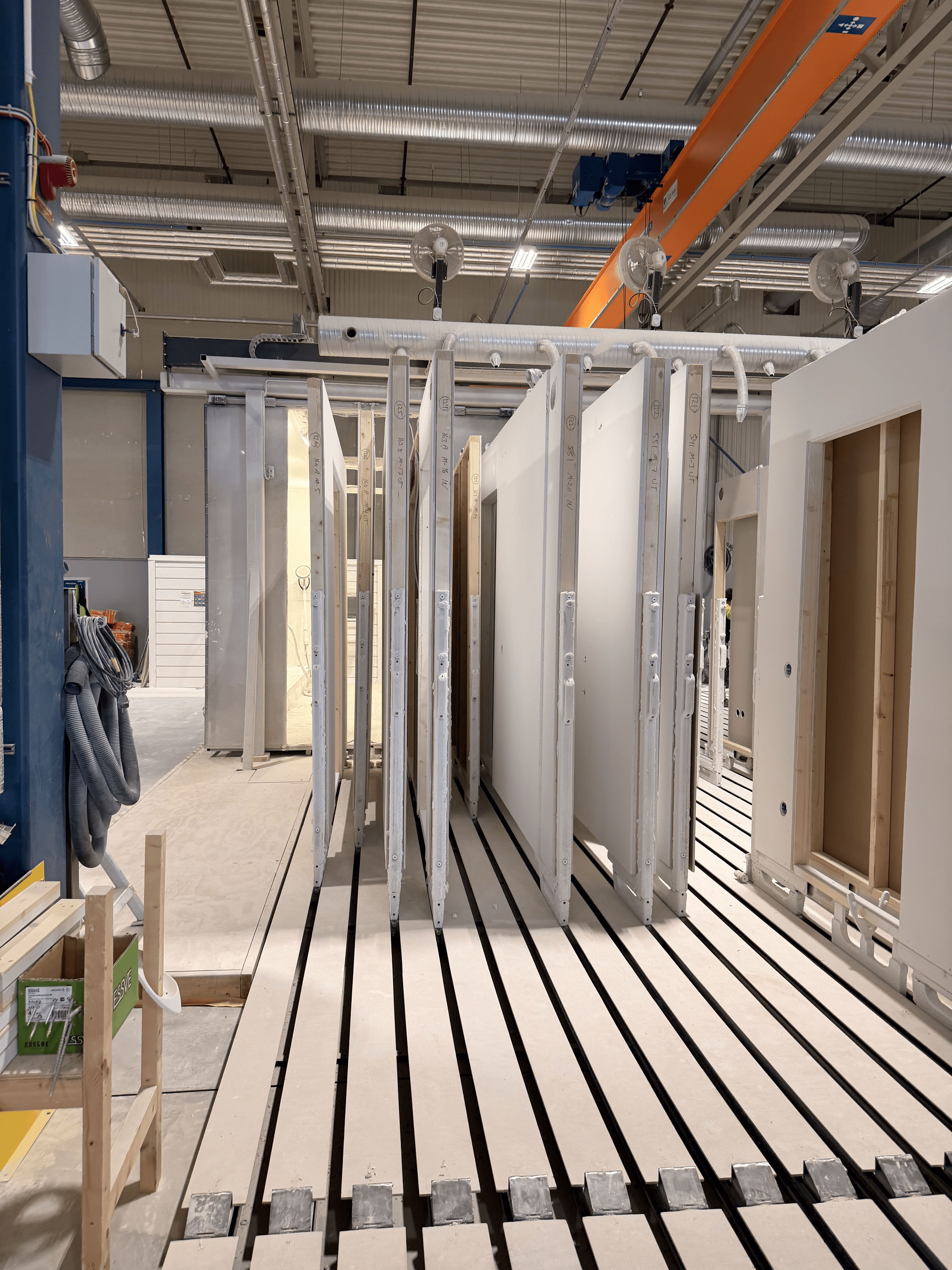 Walls standing on carts in a vertical position on the Vertitrack Finish floor tracks
