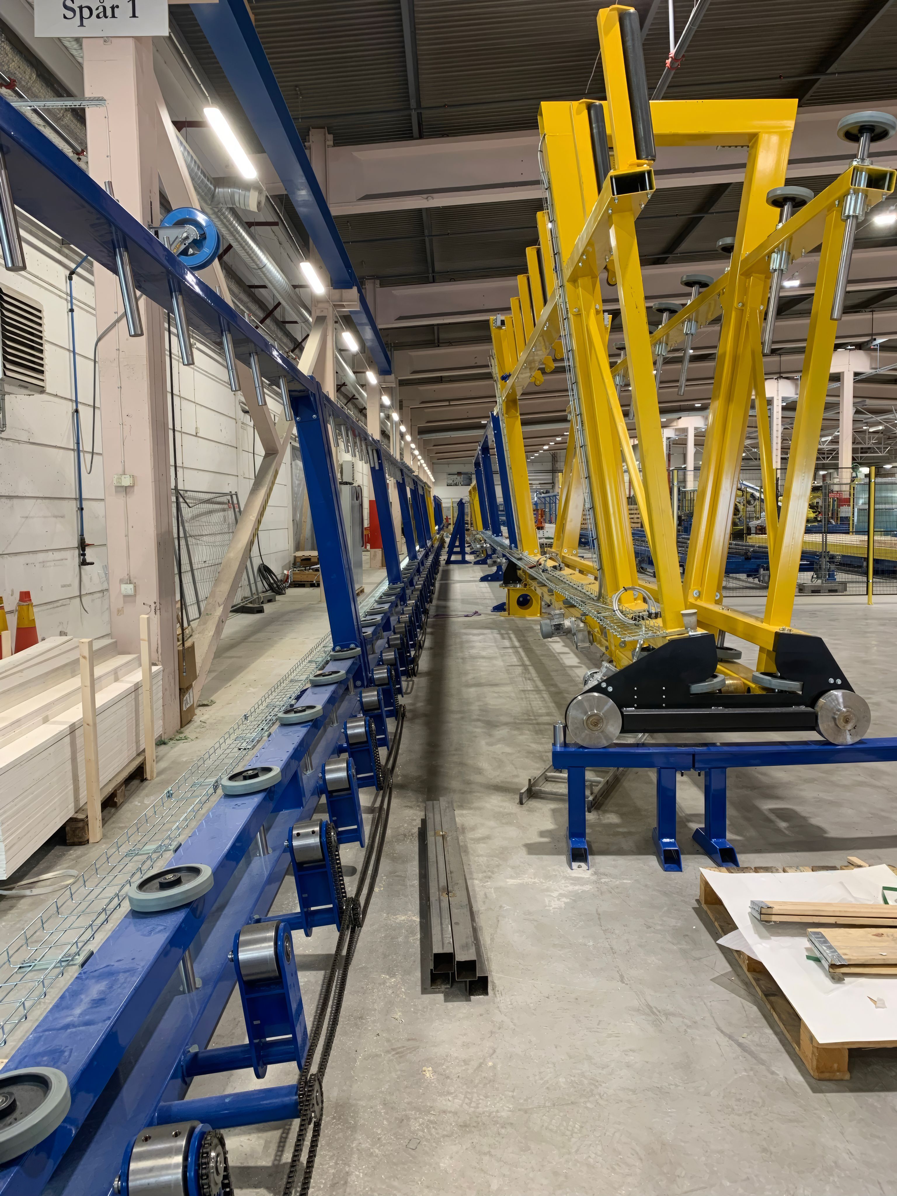 The Vertistore sorting robot running along the storage racks at the BoKlok factory