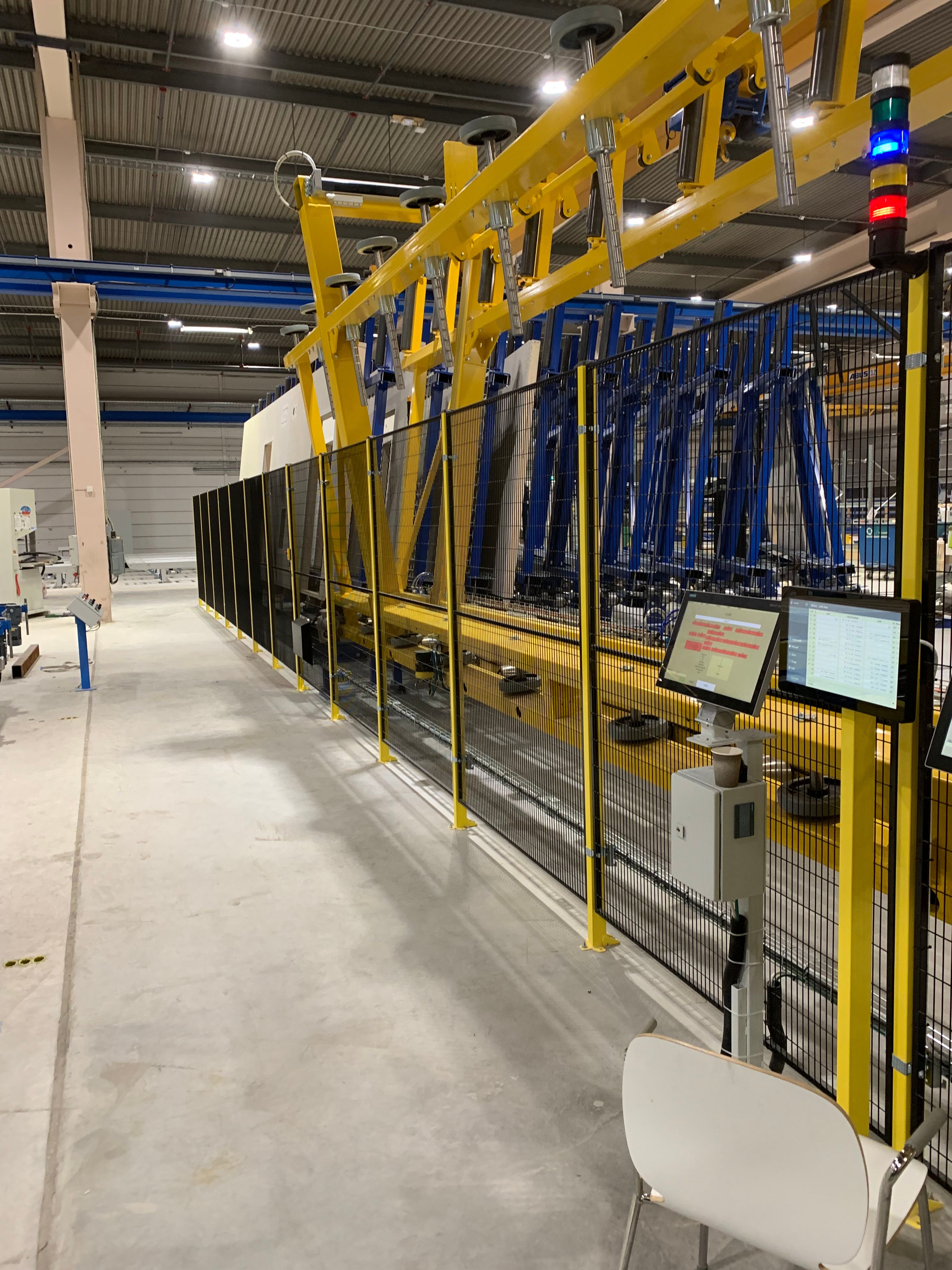 The Vertistore wall magazine and sorting gantry behind safety fencing at the BoKlok factory