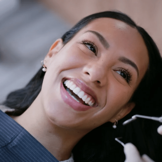 Patient in dental exam with beaming smile