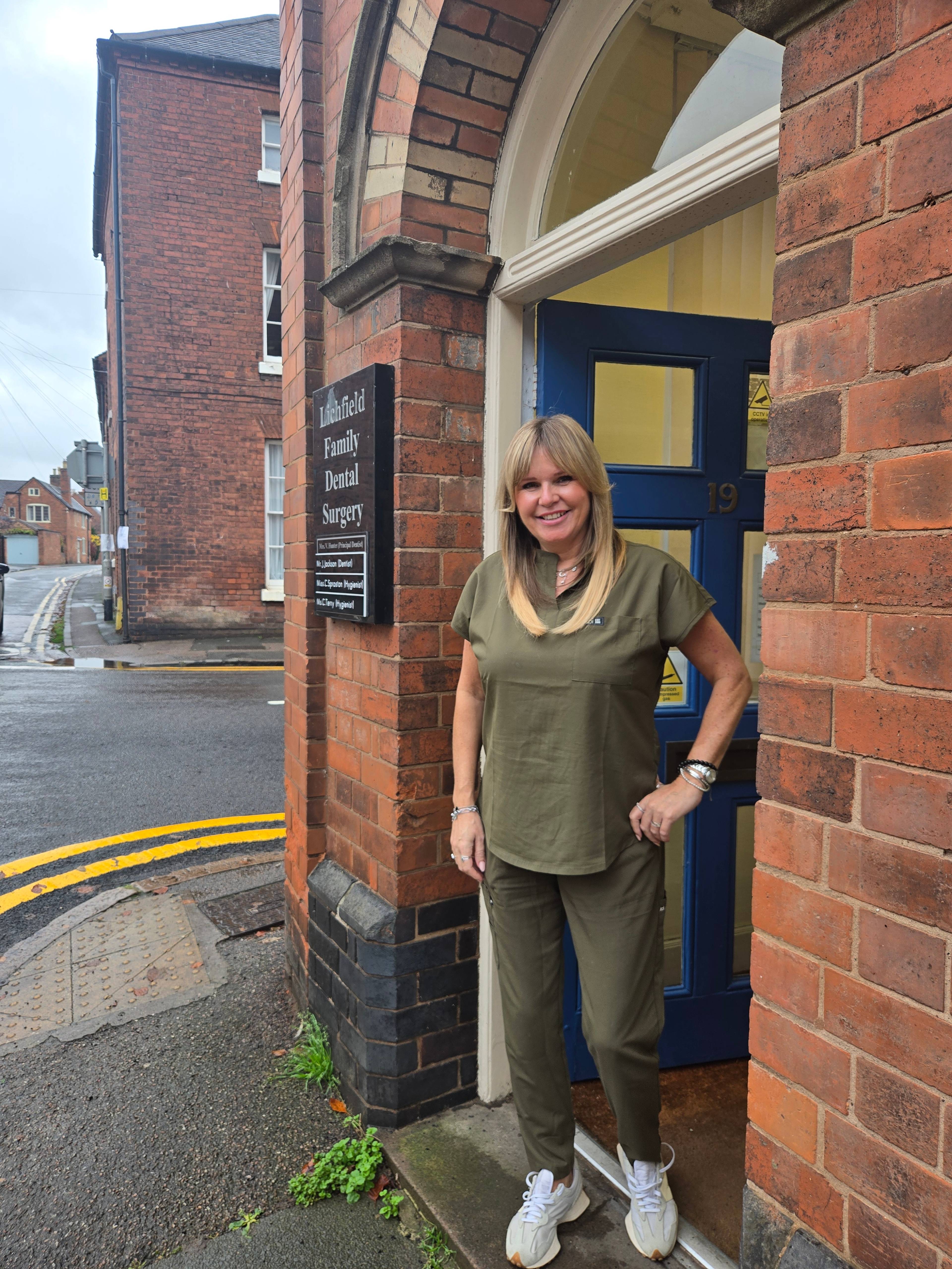 woman stood outside Lichfield dental practice 