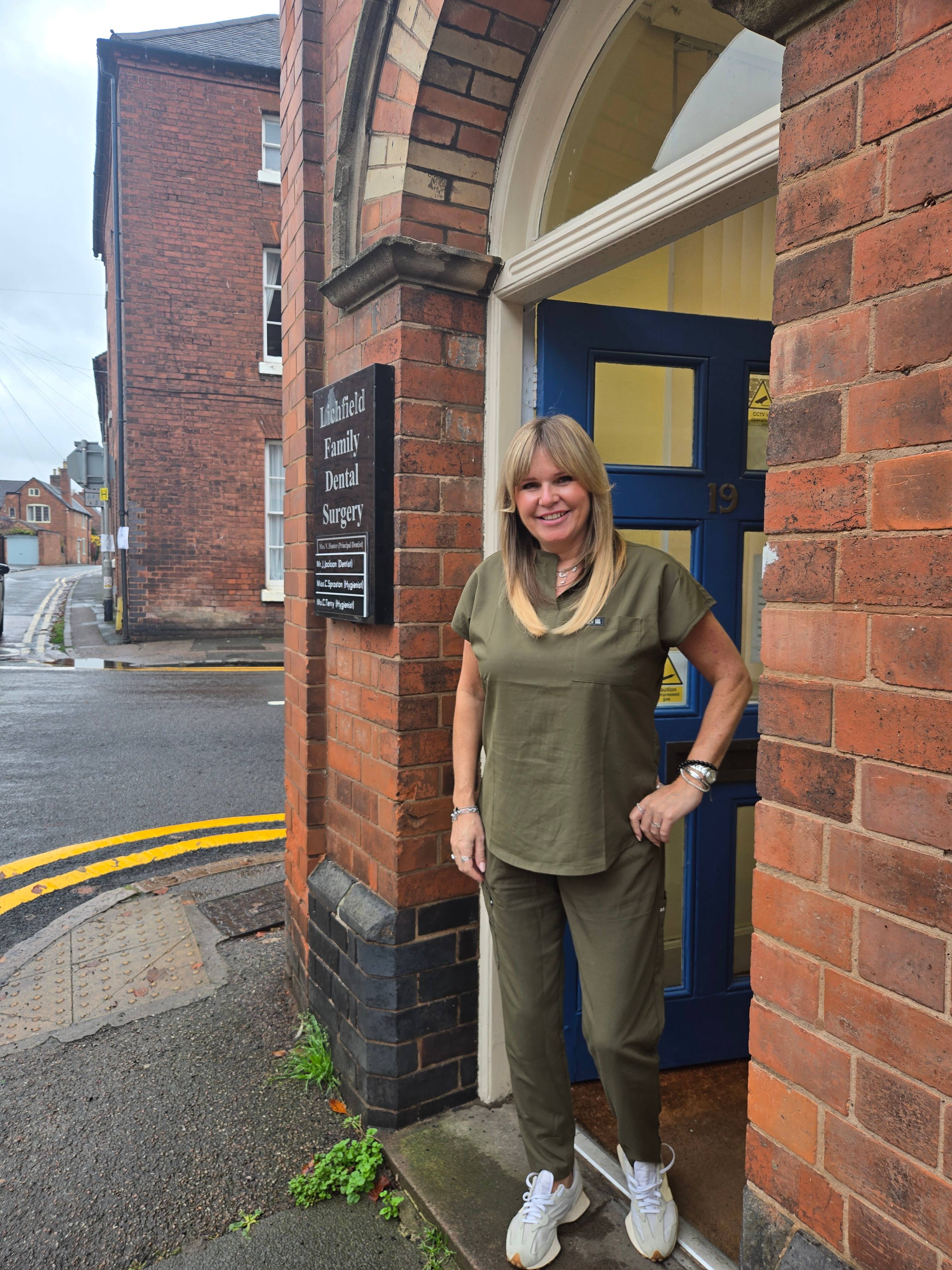 woman stood outside Lichfield dental practice