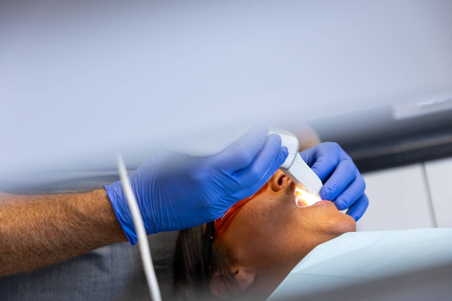 A patient having her mouth scanned for Invisalign treatment using a 3D scanner