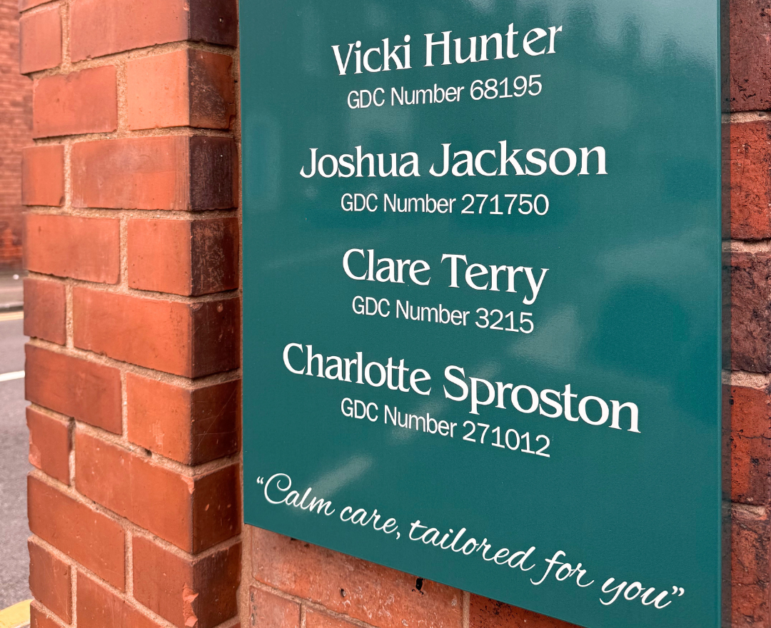 A close up of the sign at the front of the Beacon Park practice which has the names of all the staff members and their GDC numbers