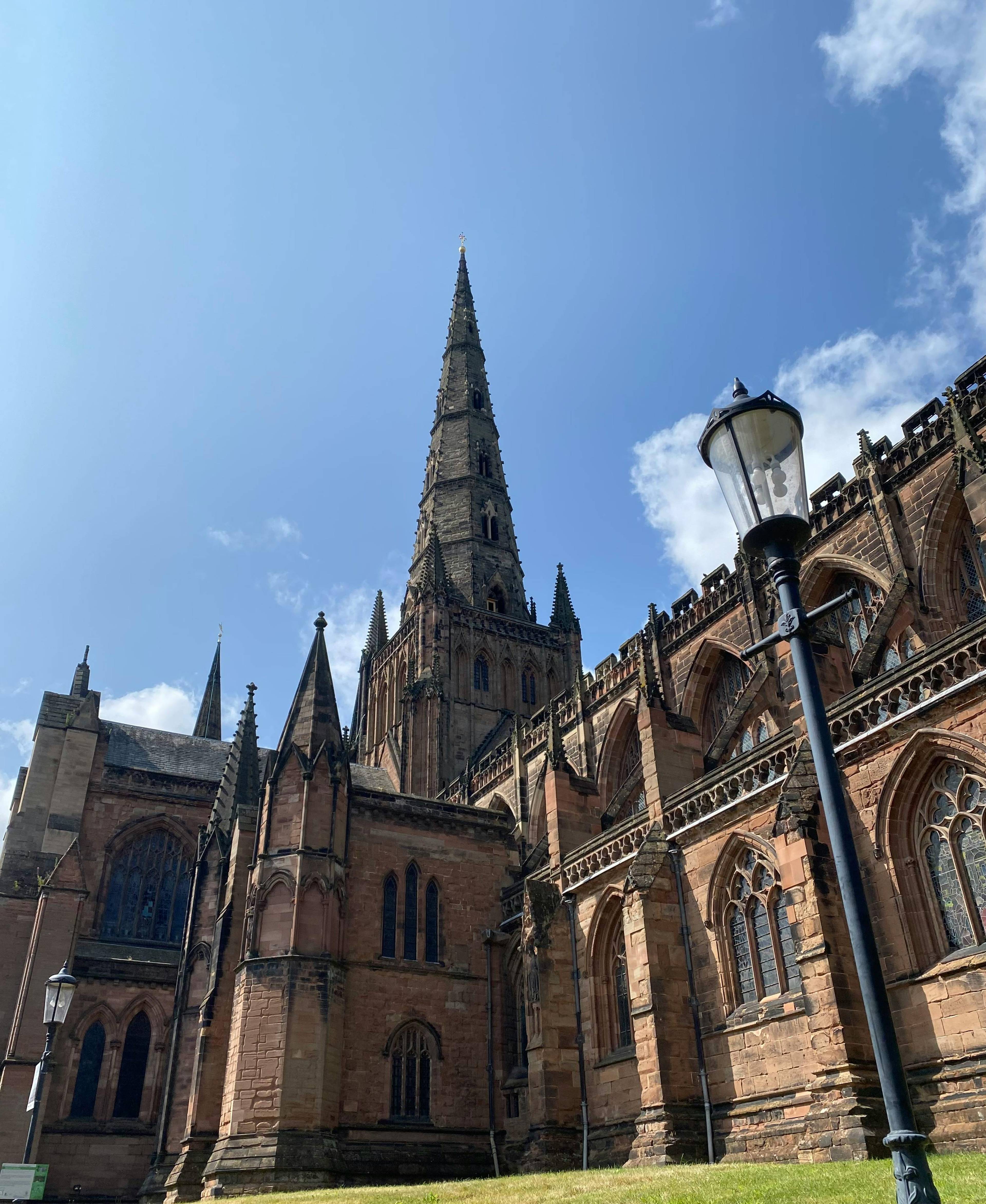 Lichfield cathedral under a sunny blue sky
