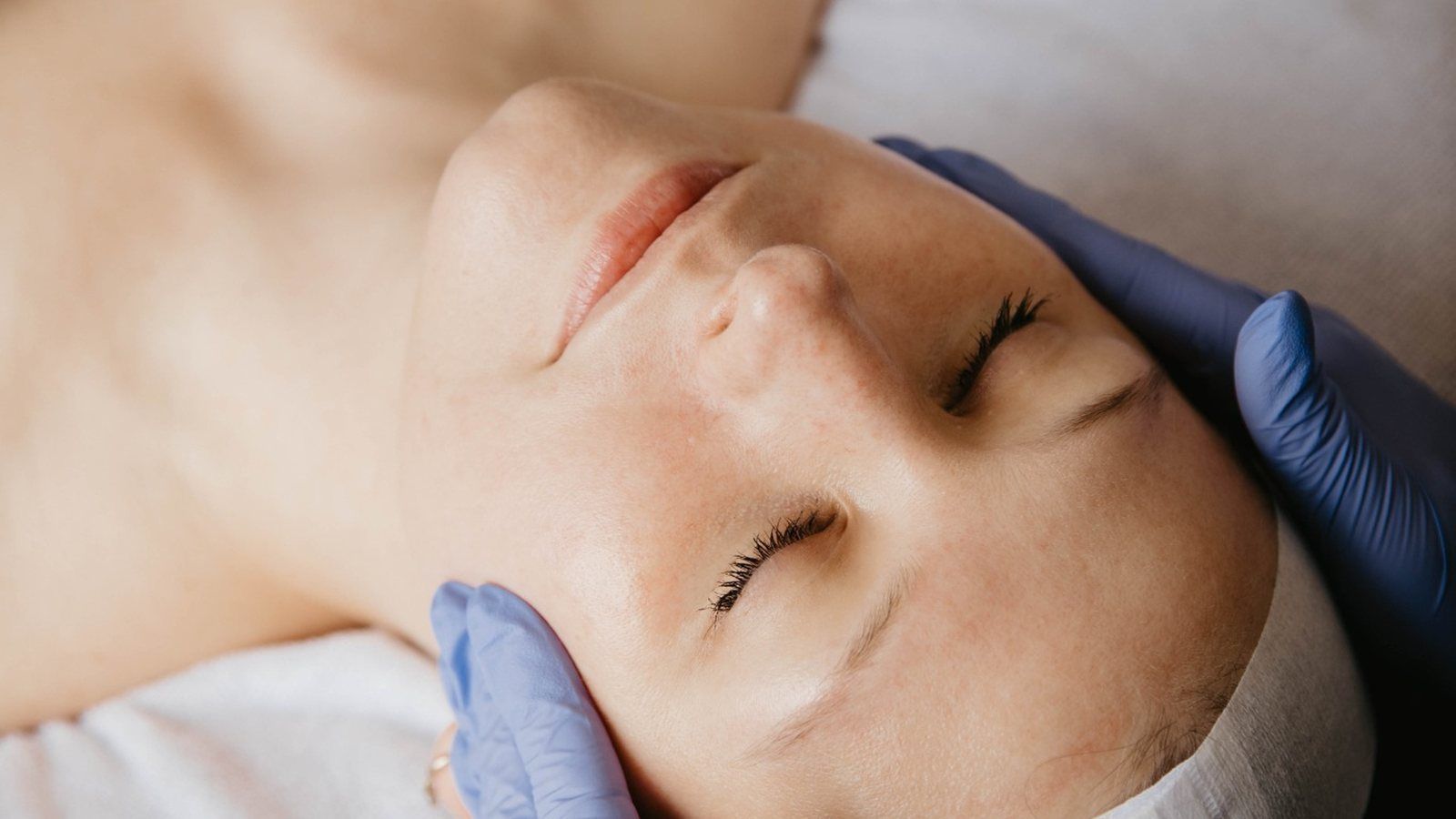 Close detail of even, glowing skin in soft light
