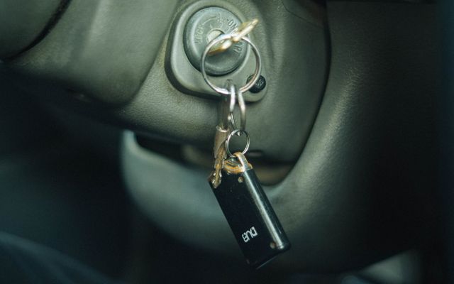 a car door handle with a keychain hanging from it