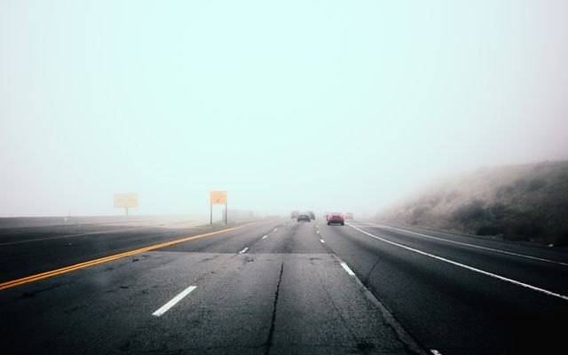 Cars driving on a foggy highway