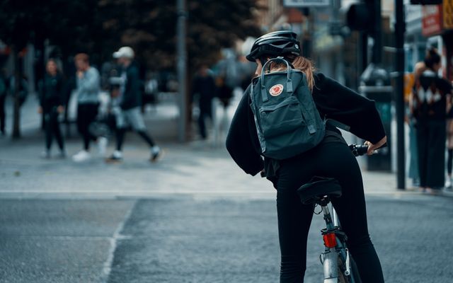 Cyclist riding on a road alongside traffic