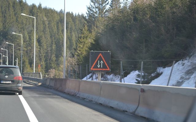 Road sign indicating two-way traffic ahead on a highway