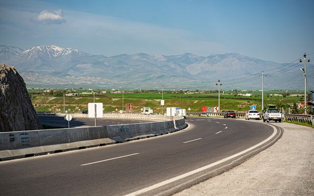 a road with a mountain in the background