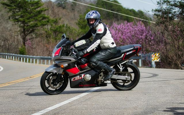 A person riding a motorcycle on a winding road.