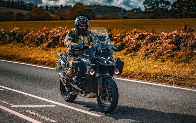 Man riding motorcycle on a paved road