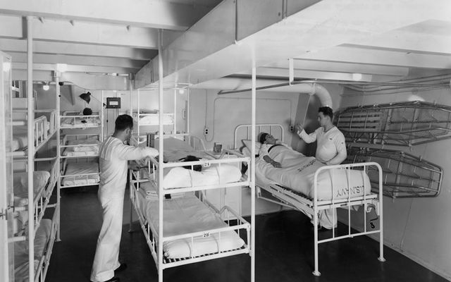 Medical ward with bunk beds and patients