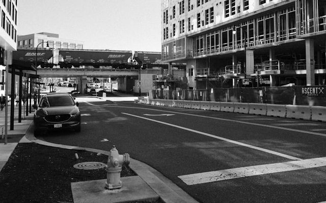 Urban street with buildings and a car.