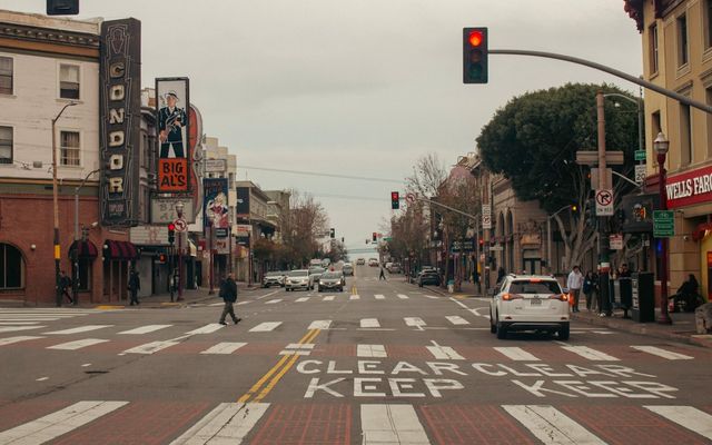 City street with cars and pedestrian crossing