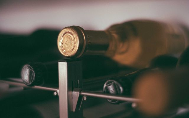 black glass bottles on rack