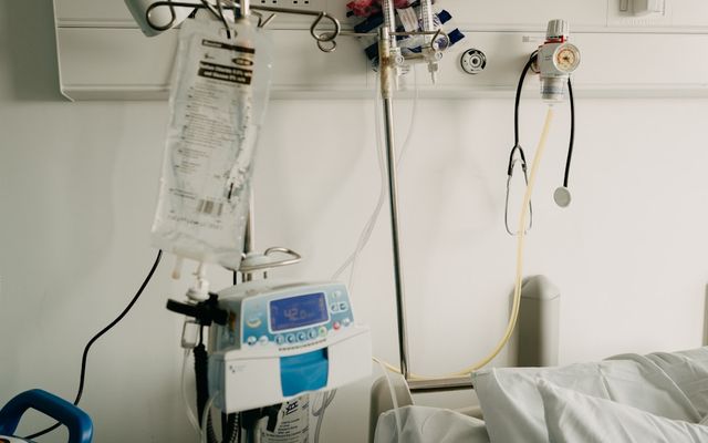 a hospital room with a bed and medical equipment