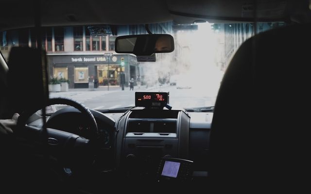 Driver using a phone while driving, illustrating distracted driving dangers