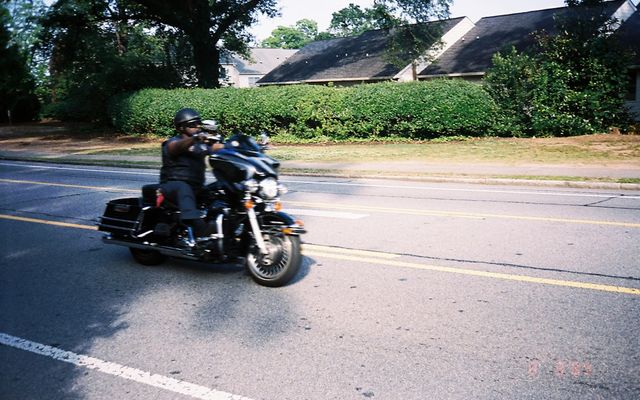 man in black jacket riding motorcycle on road during daytime