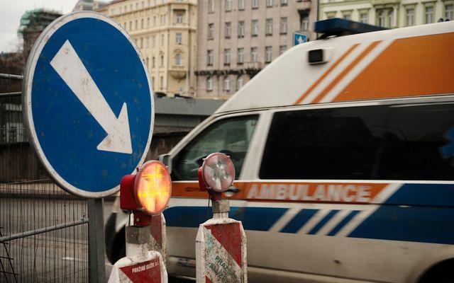 Ambulance with traffic signs and construction barriers