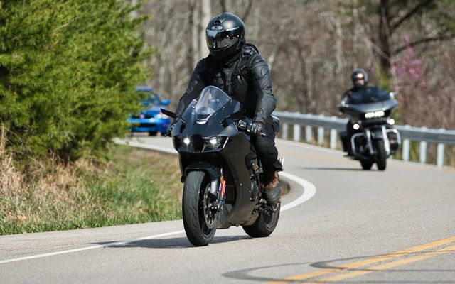 Two motorcyclists riding on a winding road